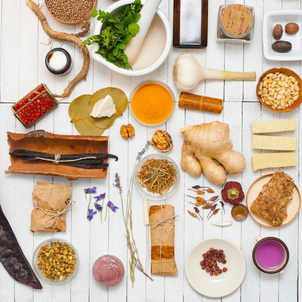 A table with herbs and bottles of medicine.